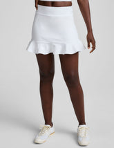 white skirt with a ruffle hem and built-in shorts with pockets.